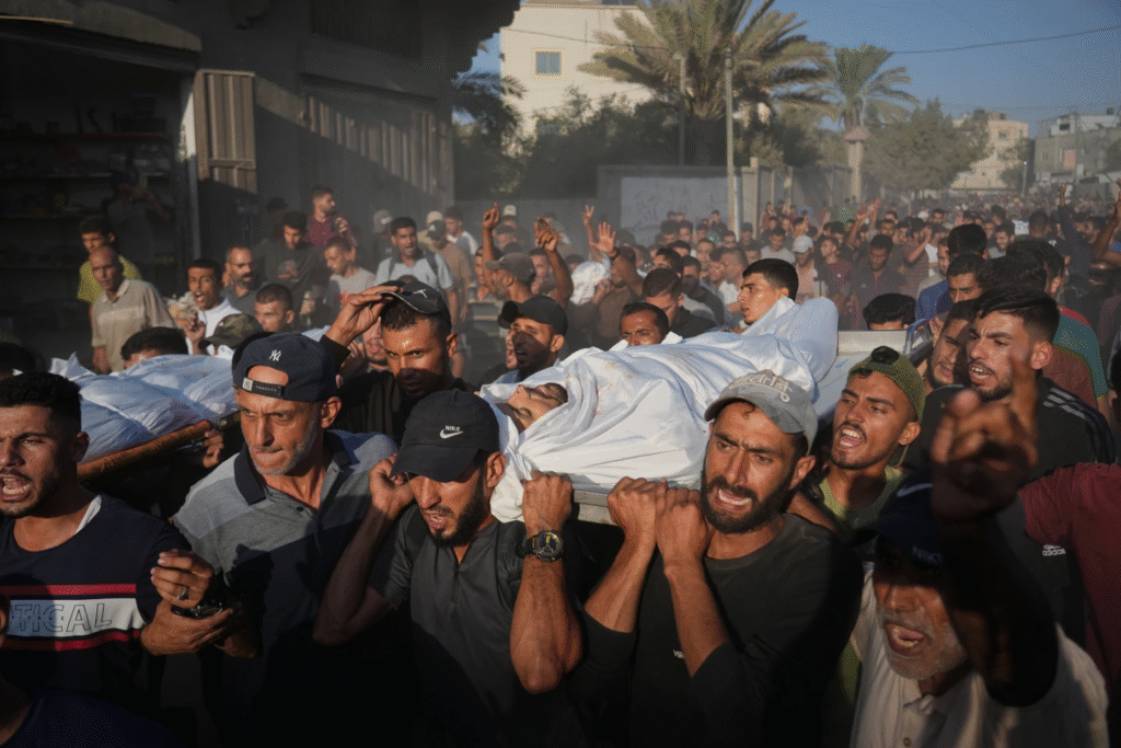 Dolientes cargan los cuerpos de palestinos muertos por fuego israelí durante su funeral en Deir al-Balah, Franja de Gaza, el domingo 19 de octubre de 2025. (Foto AP)