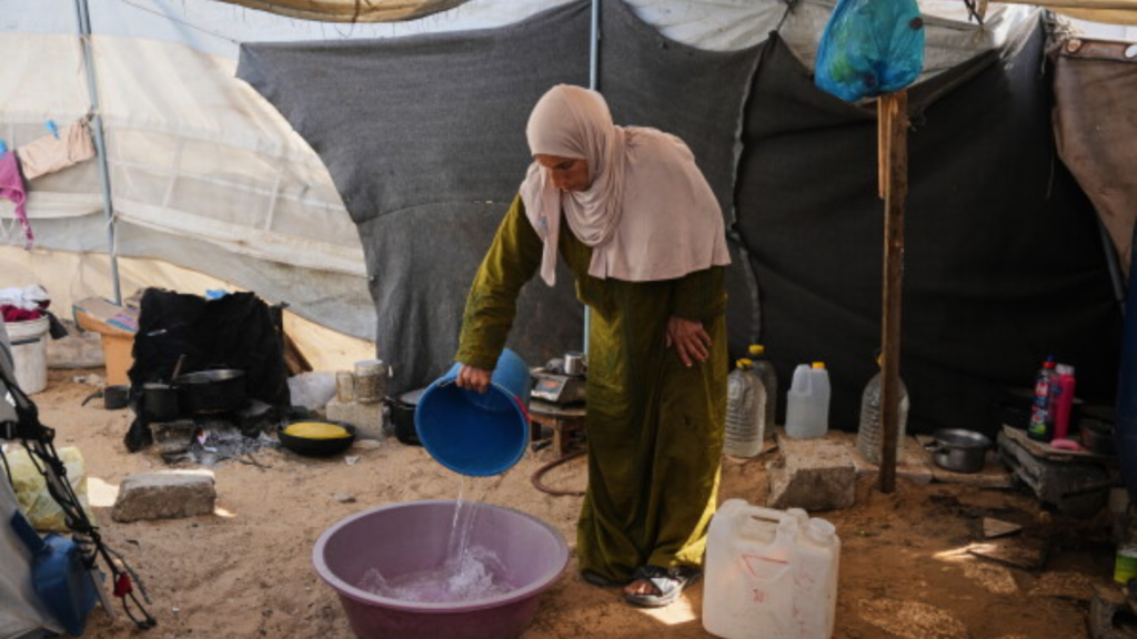 Mujer palestina reutiliza agua en Gaza ante la crisis del agua y la escasez de recursos básicos provocada por la emergencia humanitaria.
